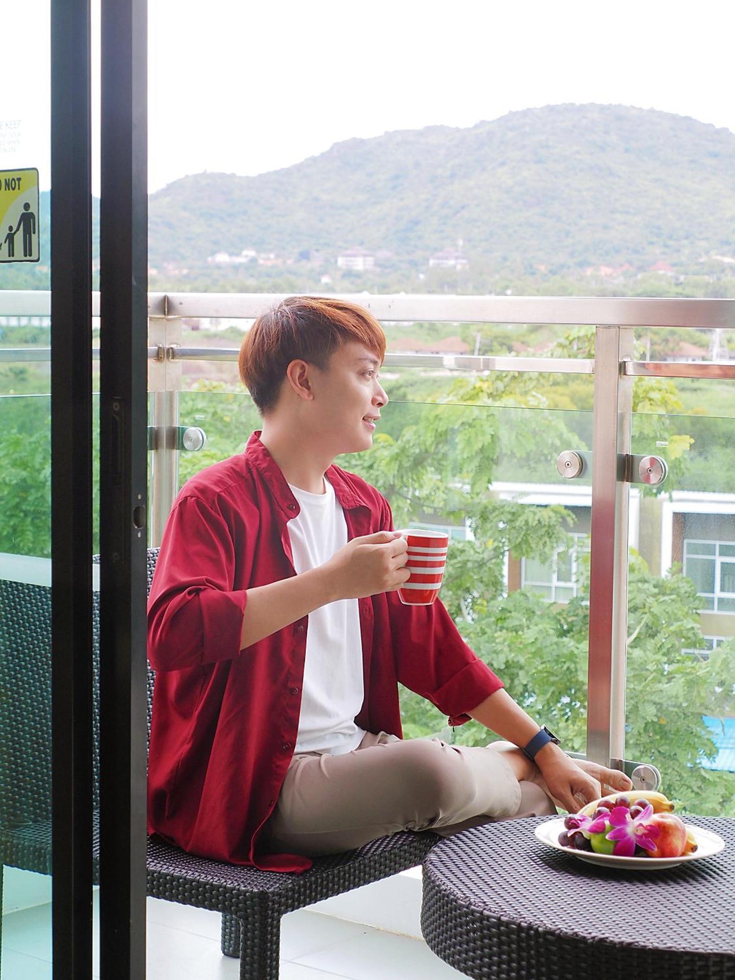 Amari Hua Hin Hotel Exterior photo A man drinking coffee