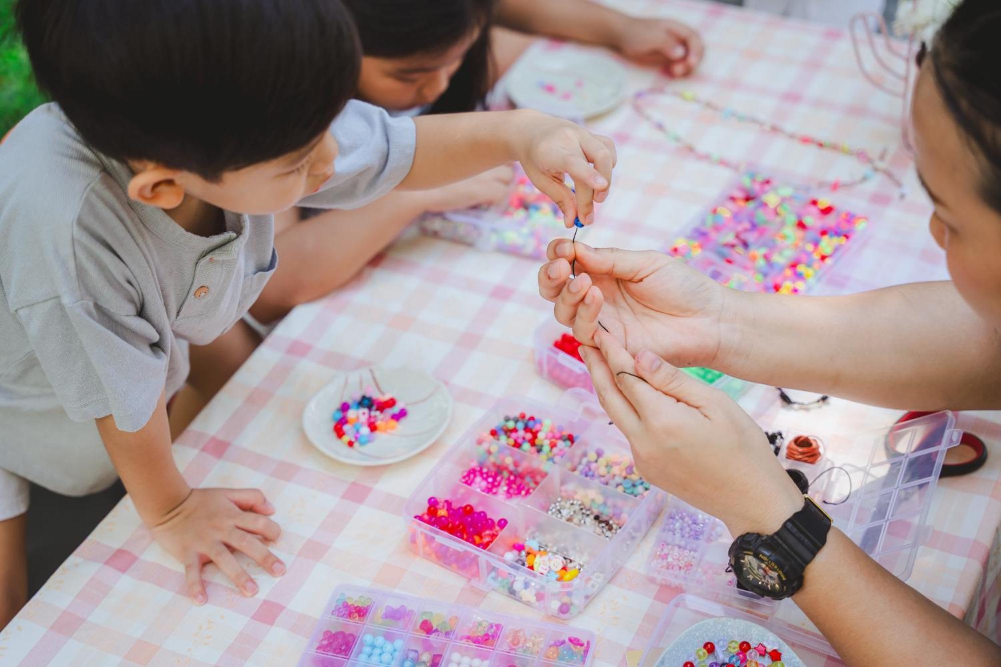 Amari Hua Hin Hotel Exterior photo Children making bead bracelets